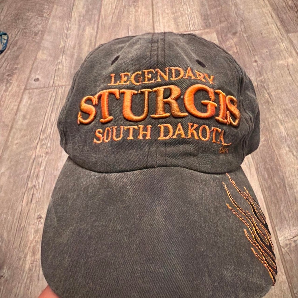 Legendary Sturgis South Dakota cap with orange embroidered text and Flames'